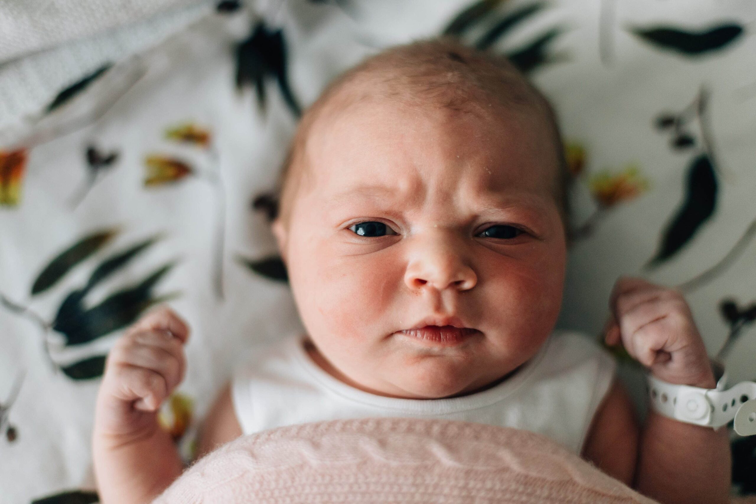 newborn baby martha scowling at camera during fresh 48 session at Mercy Hospital