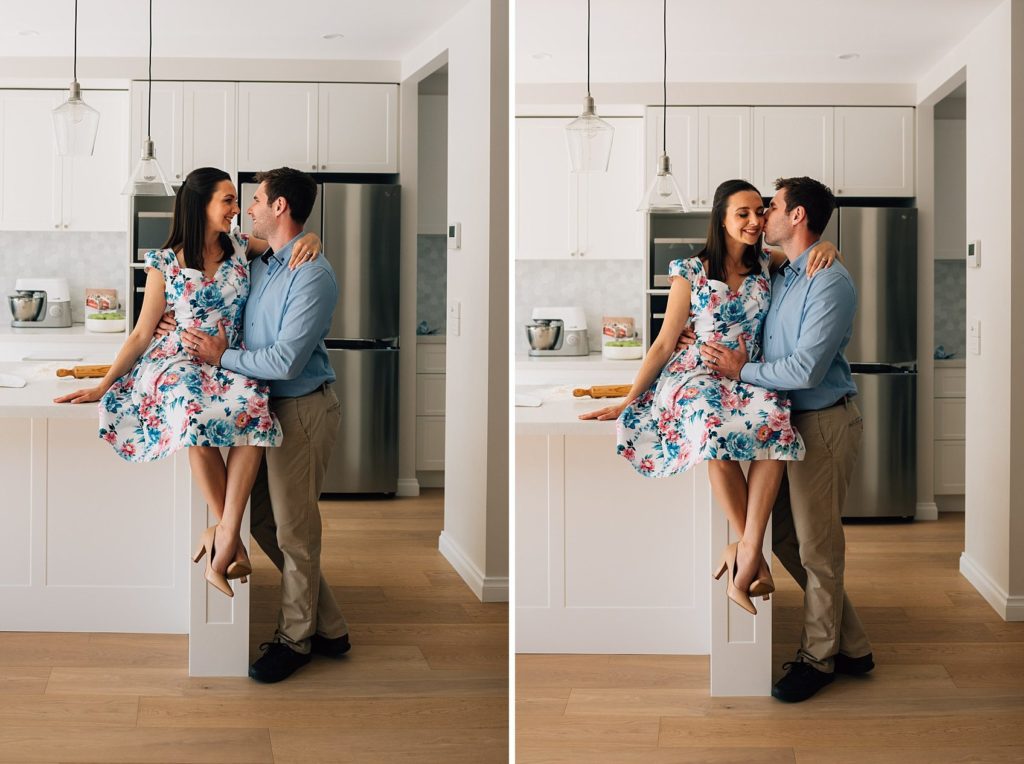 bun in the oven pregnancy announcement ideas with wife sitting on kitchen counter, embraced by husband