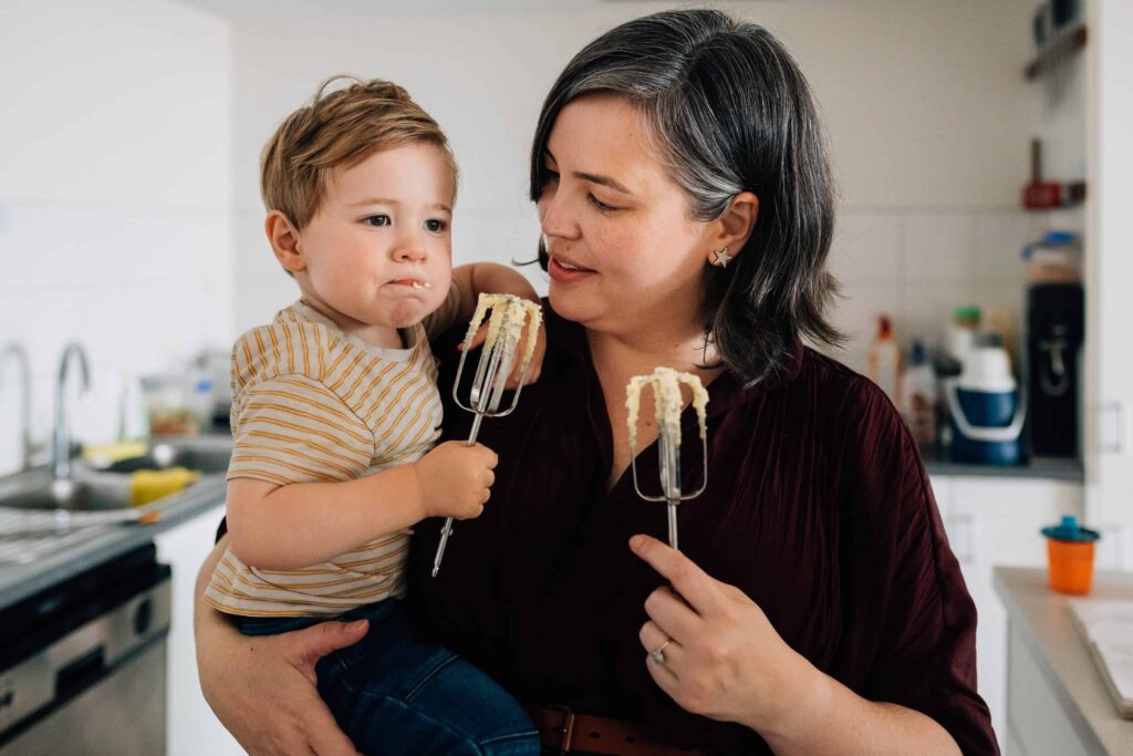 Boy eating mixture from cooking beaters, value of photography, especially plus size family photos