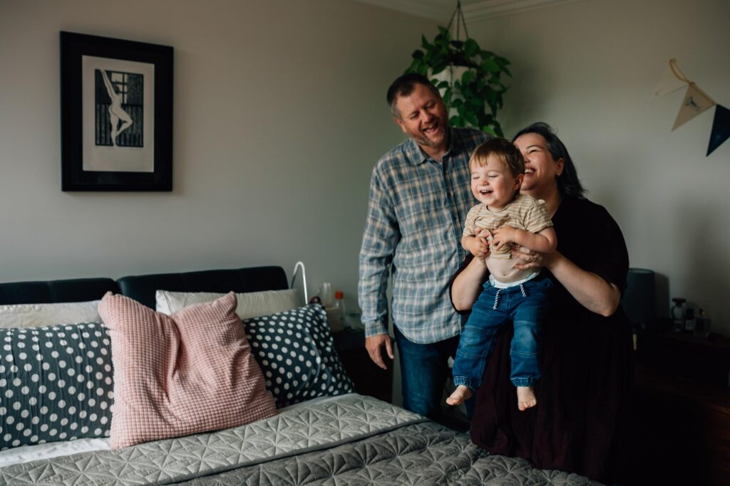 Mum about to throw son onto bed as a game, value of photography, especially plus size family photos